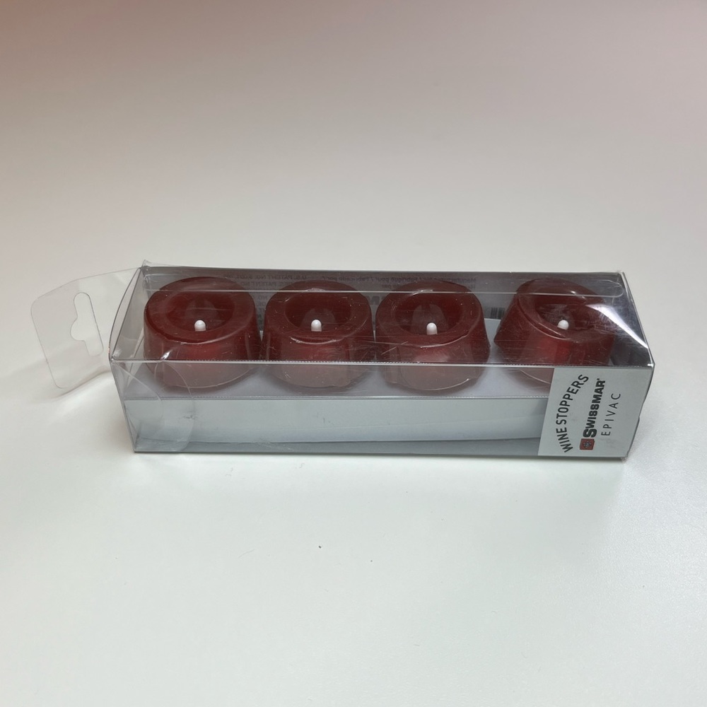 Swissmar wine stoppers. 4 pack. Never used and in unopened pack. Color: Burgundy